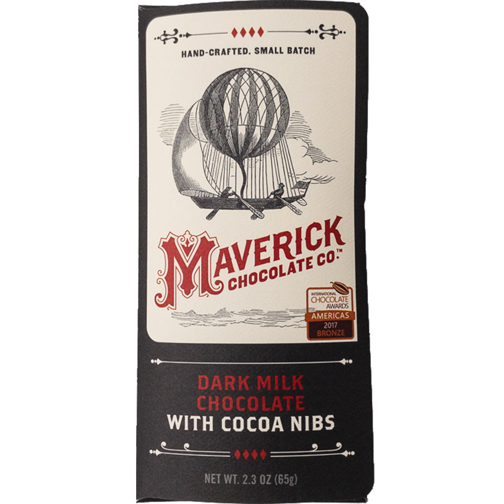 60% dark milk chocolate bar and cocoa nibs arranged on an artisan chocolate workbench